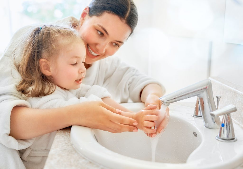 A mom and daughter ward off the flu virus by keeping their hands clean.